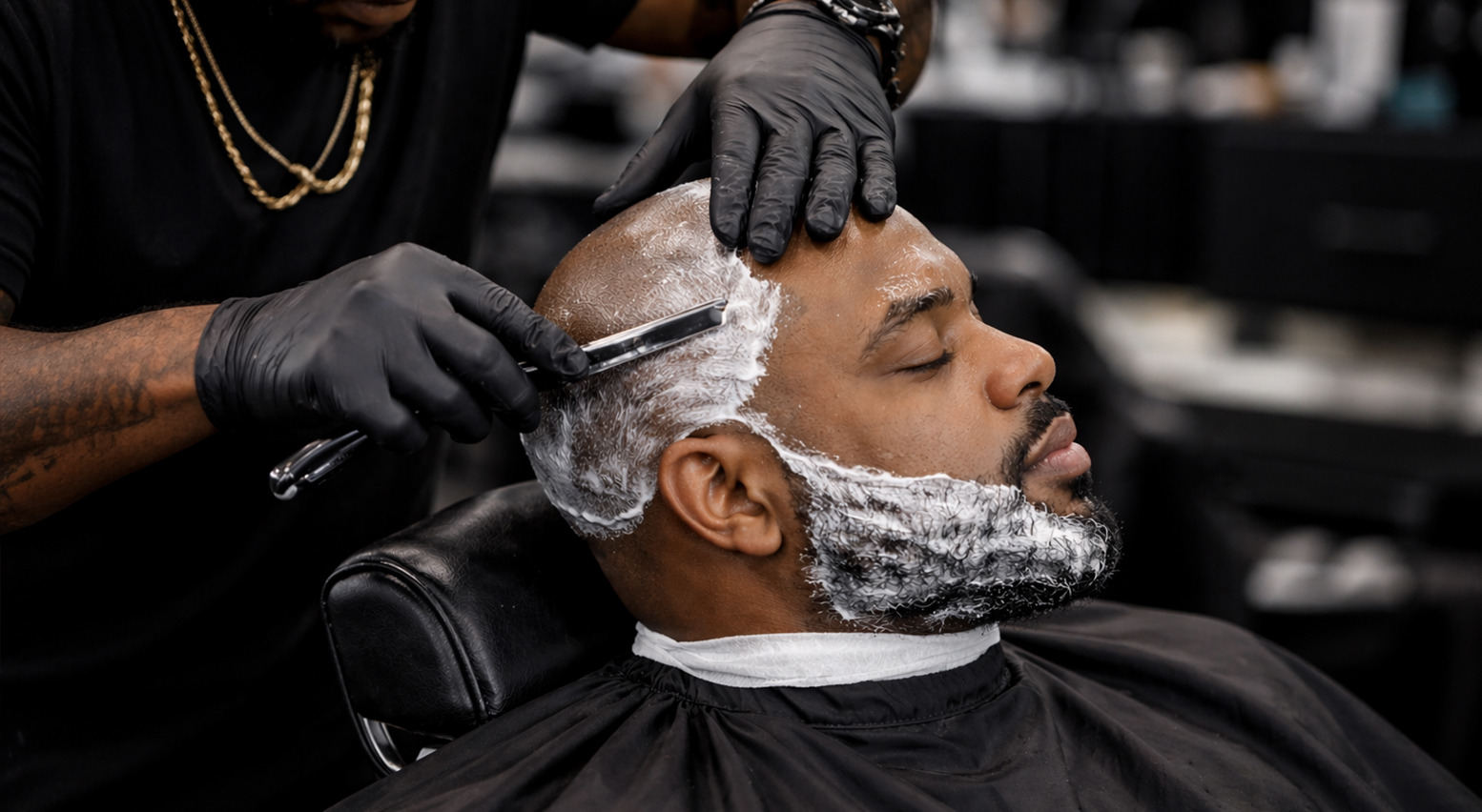 Barber razor-detailing a client's head